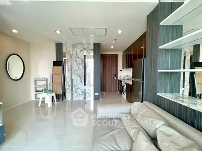 Modern living room with sleek design, featuring marble accents and stylish furniture in a luxurious apartment.