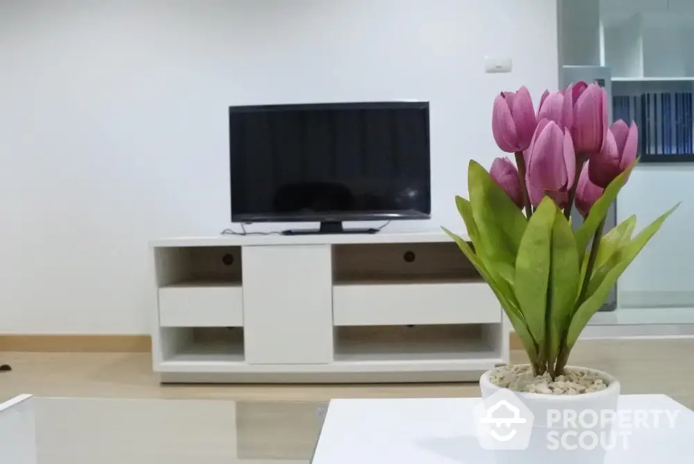 Modern living room with sleek TV stand and vibrant tulip decor