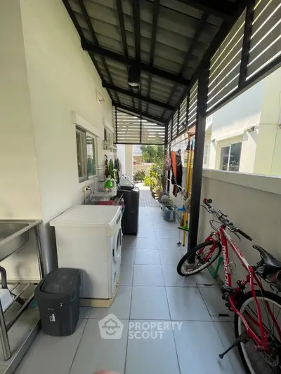 Charming outdoor utility area with washing machine and bicycle, perfect for practical living.