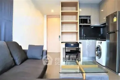 Modern apartment living room with sleek kitchen and built-in appliances