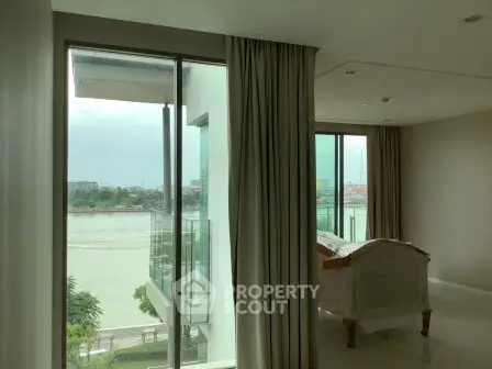 Luxurious living room with stunning river view and floor-to-ceiling windows in modern apartment.