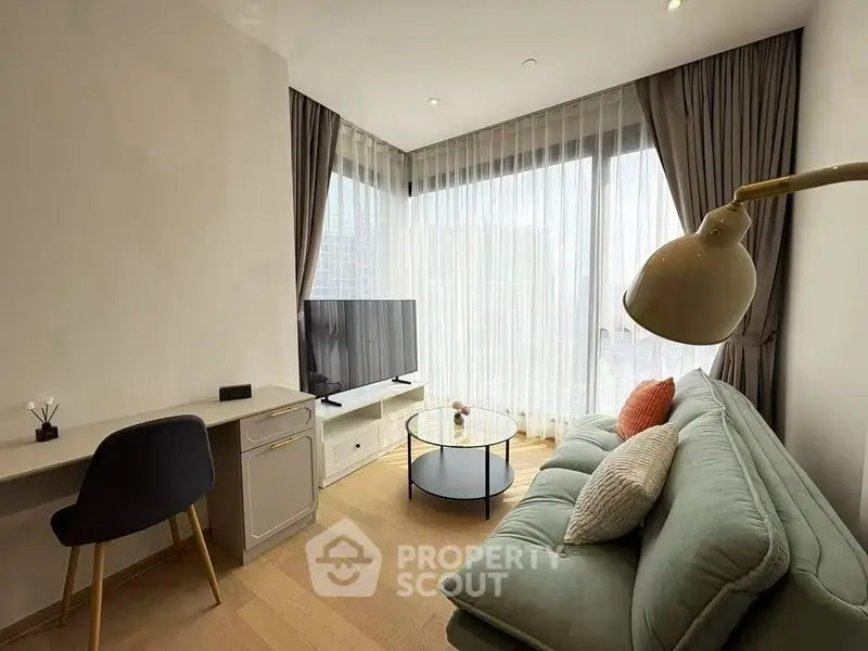 Modern living room with stylish decor and large windows offering city views.