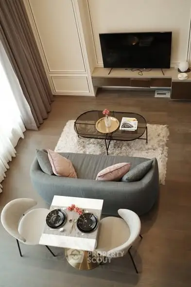 Elegant living room with modern decor, cozy seating, and stylish dining area, perfect for urban living.