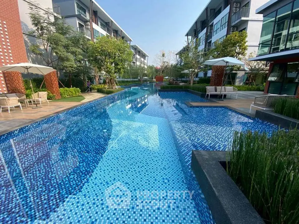 Luxurious residential complex with stunning outdoor pool and modern architecture.