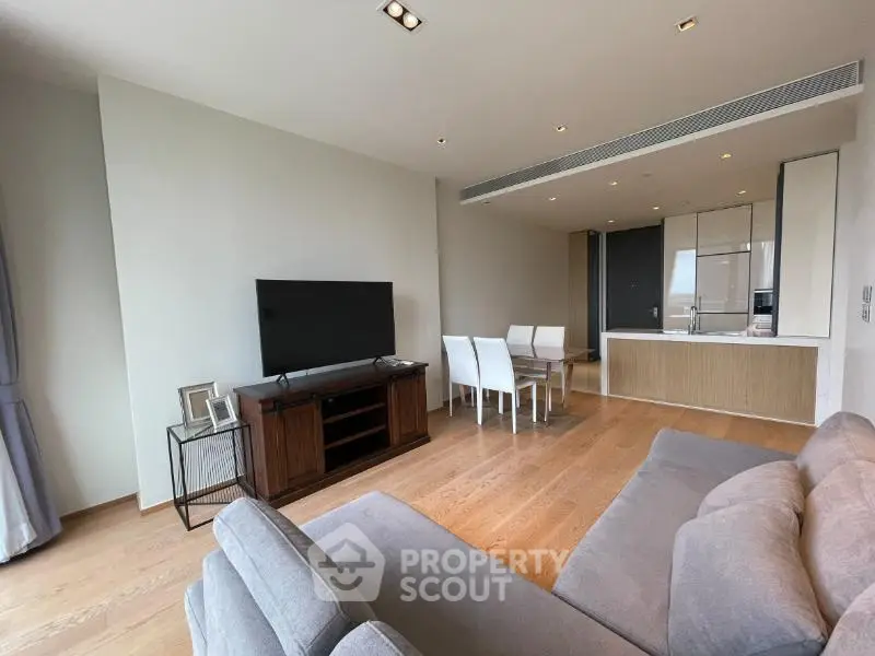 Spacious modern living room with open kitchen and elegant furnishings