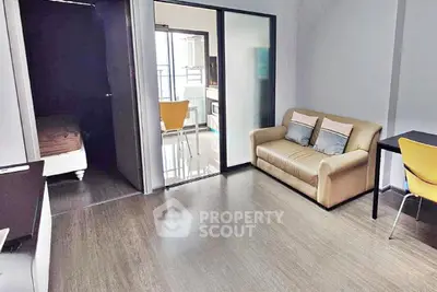 Modern living room with cozy sofa and dining area in open layout apartment