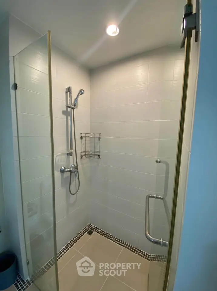 Modern bathroom with glass shower enclosure and sleek fixtures