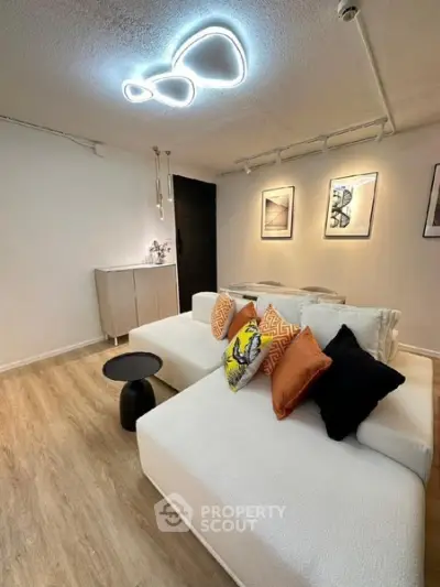 Modern living room with stylish lighting and cozy white sofa