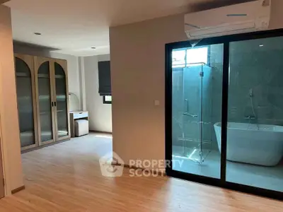 Spacious bedroom with ensuite bathroom featuring a luxurious bathtub and modern design.
