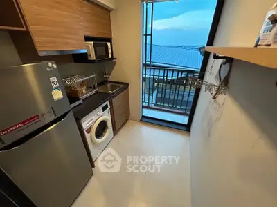 Modern kitchen with appliances and balcony view in a stylish apartment