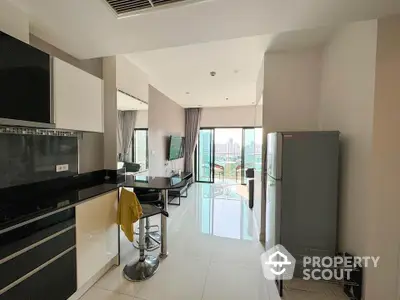 Modern open-layout kitchen and living room with city view balcony