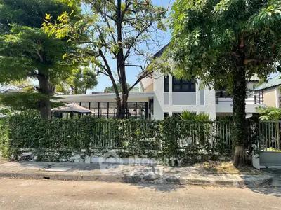 Modern two-story house with lush greenery and stylish exterior design