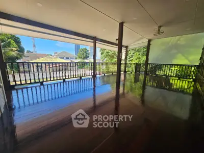 Spacious balcony with polished wooden floors and scenic view