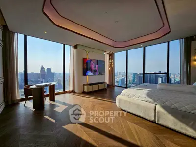 Luxurious bedroom with panoramic city views and modern design in high-rise apartment.