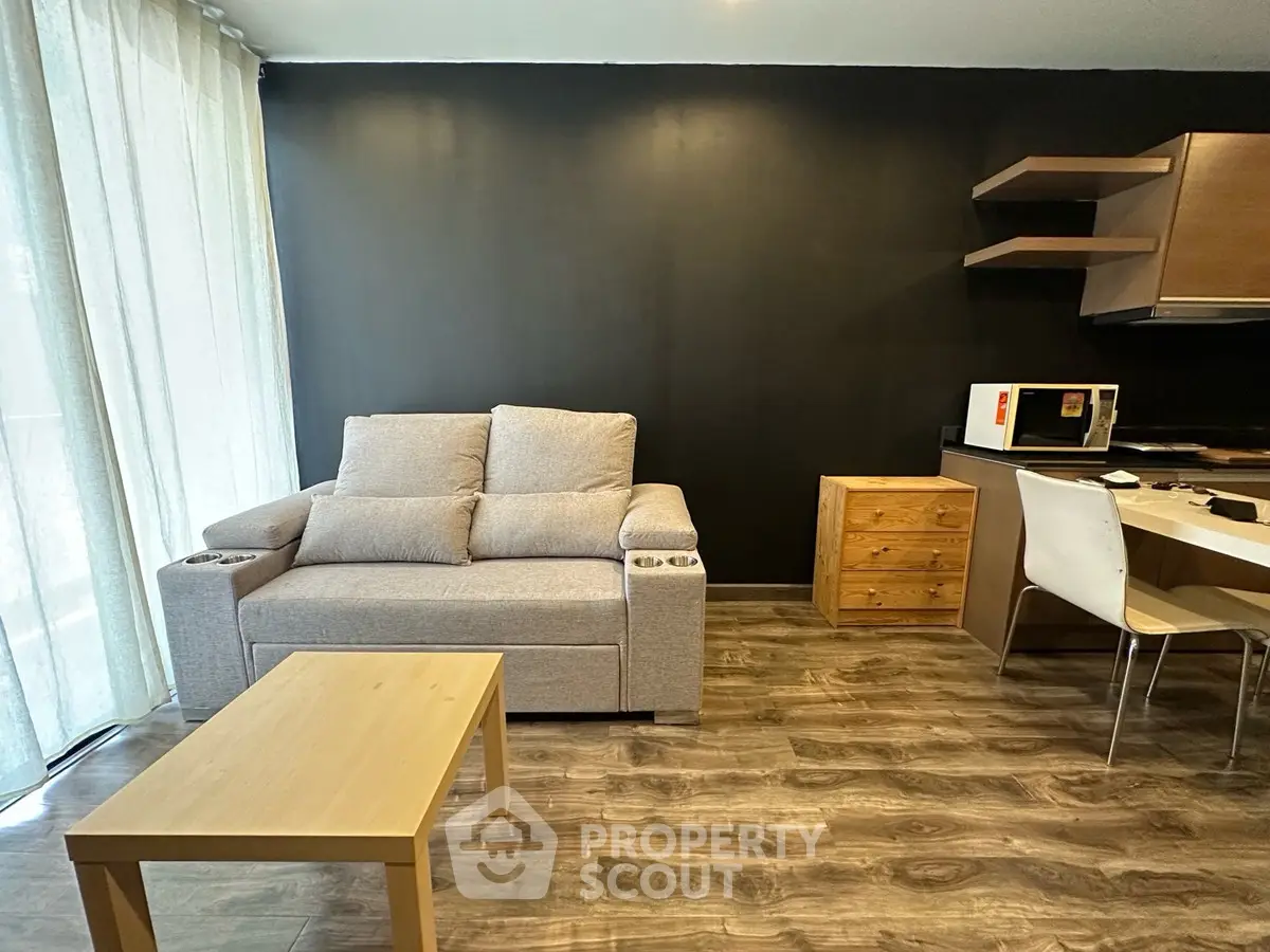 Modern living room with cozy sofa and stylish kitchen area