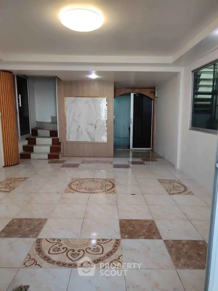 Spacious interior with elegant tiled flooring and modern design elements.