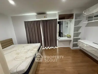 Modern bedroom with wooden flooring and built-in storage solutions