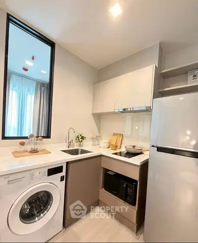 Modern kitchen with sleek design and built-in washing machine