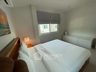 Cozy bedroom with modern decor and natural light, featuring a comfortable bed and stylish furnishings.