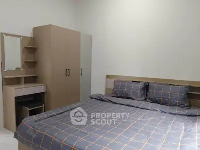 Modern bedroom with stylish furniture and cozy bedding in a contemporary apartment.