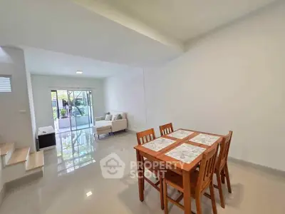 Spacious open-plan living and dining area with modern furnishings and natural light.