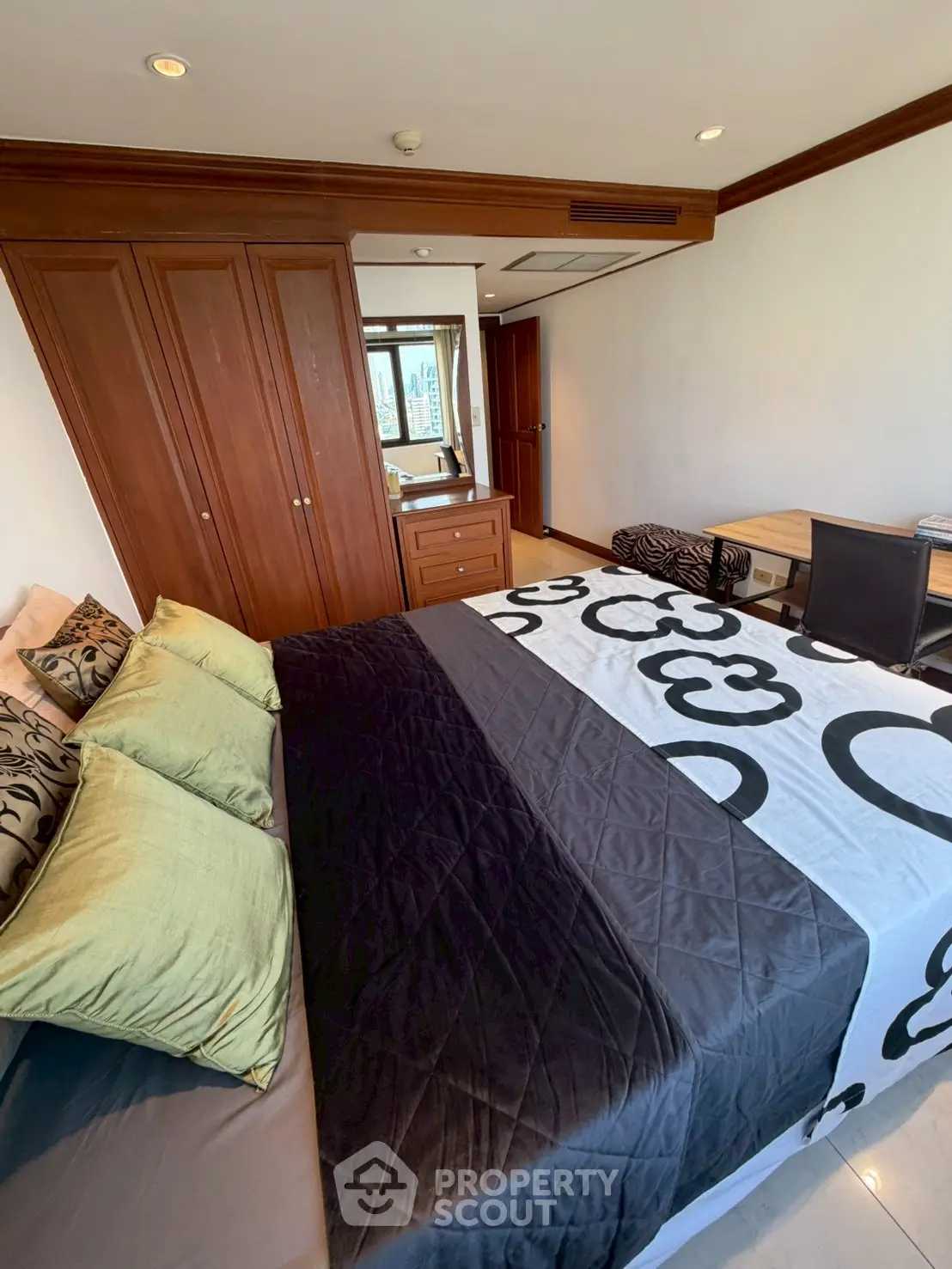 Spacious bedroom with elegant wooden wardrobe and modern decor