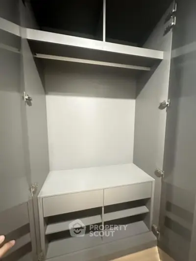Spacious modern walk-in closet with ample shelving and storage space.