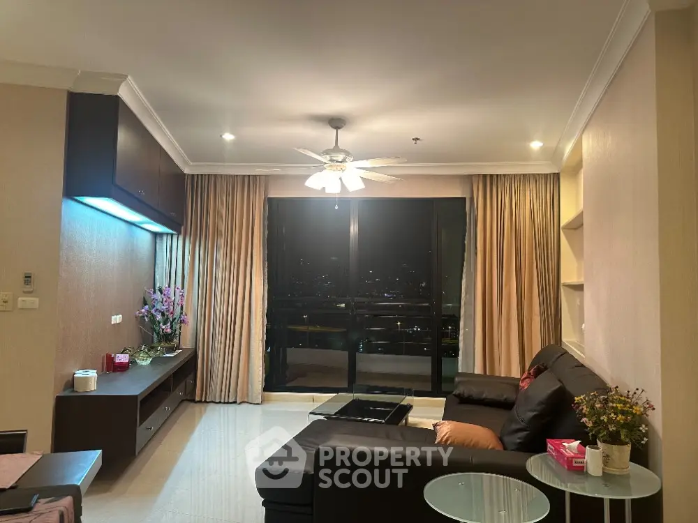 Luxurious living room with stunning city view and elegant furnishings.