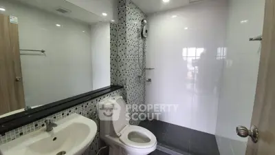 Modern bathroom with sleek fixtures and mosaic tile accents