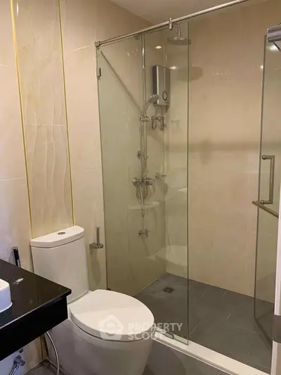 Modern bathroom with glass shower enclosure and sleek fixtures