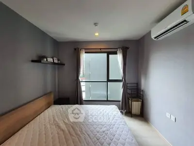 Modern bedroom with large window and air conditioning in a stylish apartment.