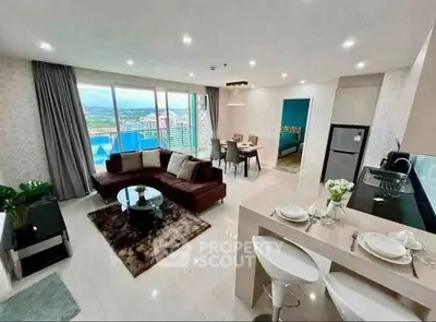 Luxurious open-plan living room with stunning city view and modern kitchen.
