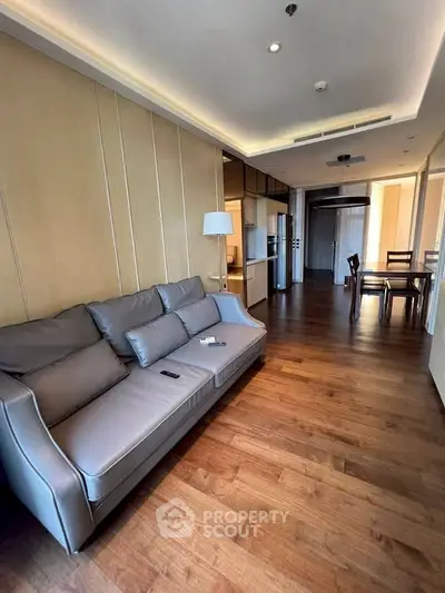 Modern living room with sleek wooden flooring and stylish furniture