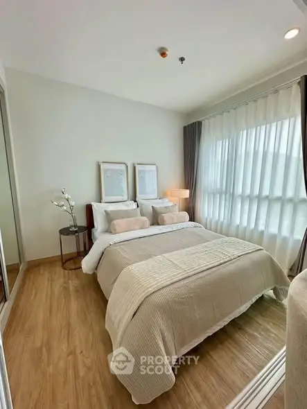 Cozy and modern bedroom with natural light and elegant decor, perfect for relaxation and comfort.