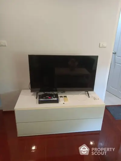 Modern living room with sleek TV setup on stylish cabinet