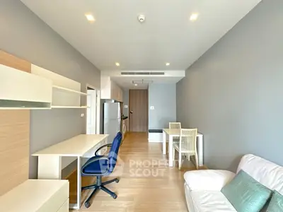 Modern living room with sleek furniture and open layout, featuring a study area and dining space.