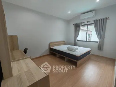 Spacious bedroom with modern furnishings and natural light