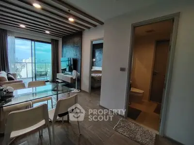 Modern apartment with open living and dining area, large windows, and city view.