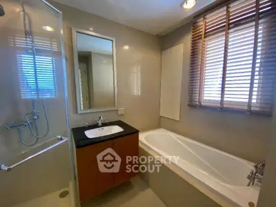 Modern bathroom with bathtub and shower in stylish apartment