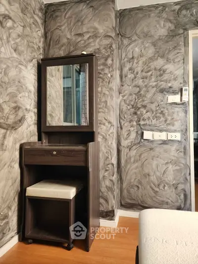 Stylish bedroom corner with unique textured walls and modern vanity set