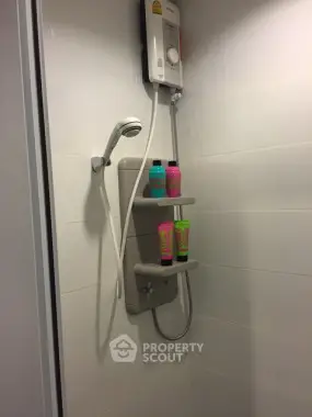 Modern bathroom shower with sleek white tiles and mounted showerhead