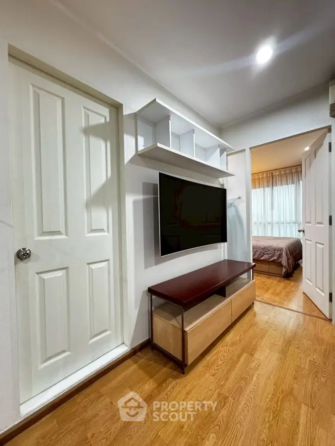 Modern interior with wall-mounted TV and cozy bedroom view