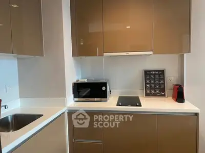 Modern kitchen with sleek cabinetry and built-in appliances in a stylish apartment.