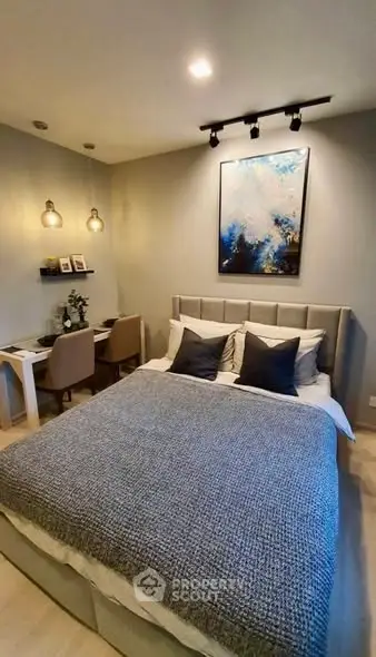 Cozy bedroom with modern decor and stylish lighting, perfect for relaxation and comfort.