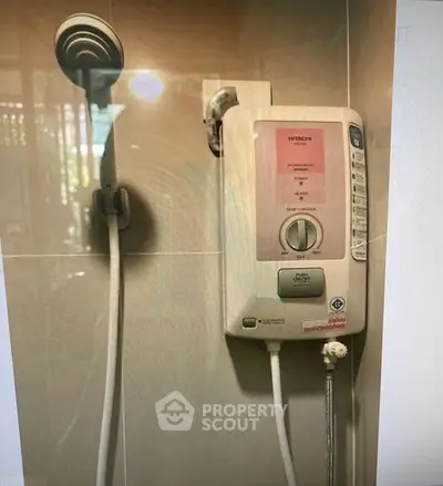 Modern bathroom with electric shower heater and sleek showerhead.