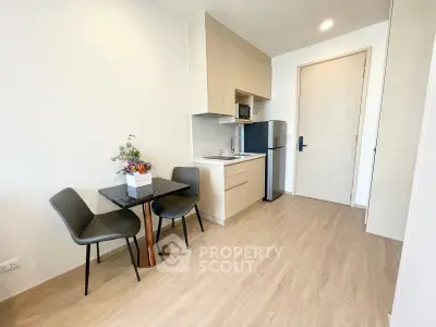 Modern compact kitchen with dining area in a stylish apartment