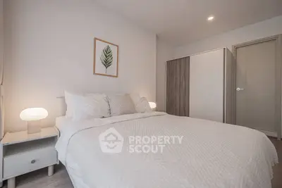 Modern bedroom with cozy bed, stylish decor, and soft lighting for a relaxing ambiance.