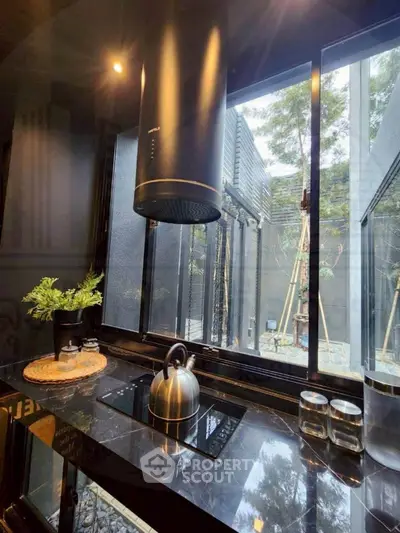 Modern kitchen with sleek black countertops and large window view