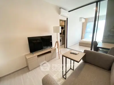 Modern living room with sleek furniture and natural light in a stylish apartment.