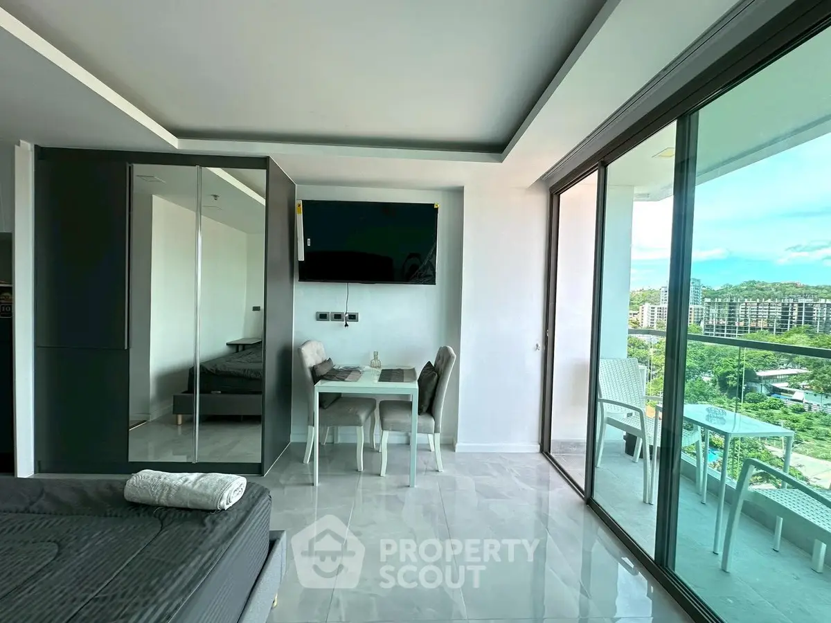 Modern apartment with sleek interior and spacious balcony offering stunning city views.